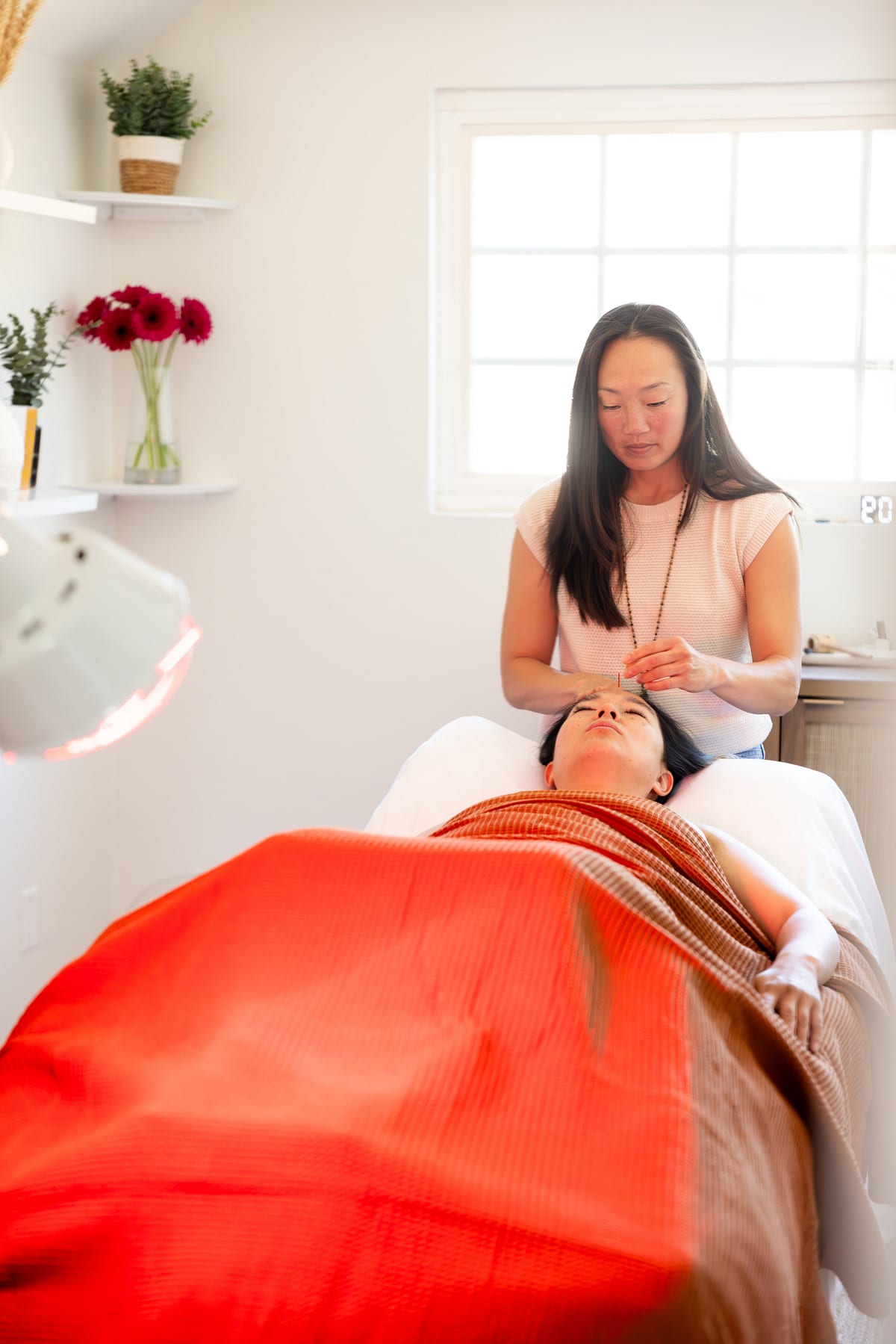 Nina placing needles during a Cosmetic Acupuncture & Whole Body Rejuvenation treatment at JungWay in Poway.